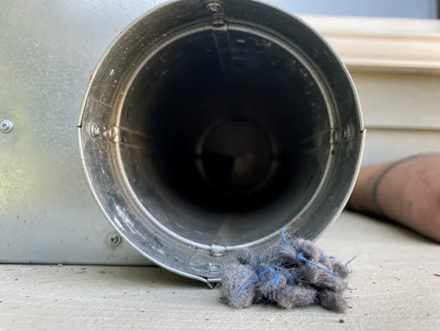Enfield Dryer Vent Cleaning technician using specialized equipment to clear severe dryer vent blockage in Enfield